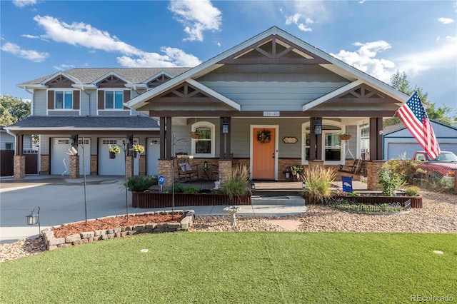 craftsman inspired home featuring a garage, concrete driveway, stone siding, covered porch, and a front yard