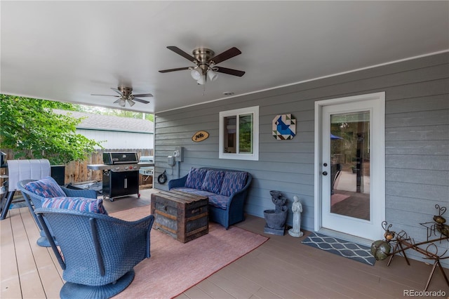 deck featuring ceiling fan, an outdoor living space, and grilling area