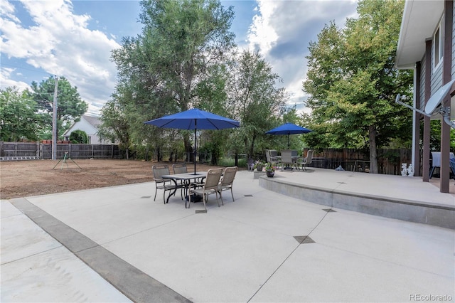 view of patio / terrace featuring fence and outdoor dining area