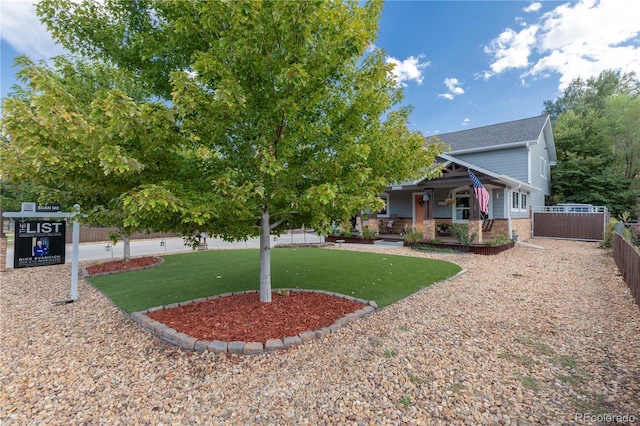 view of yard featuring a porch and fence