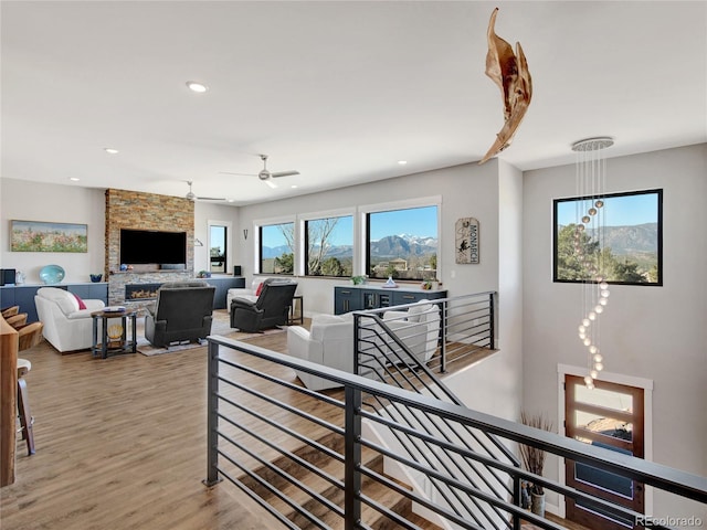 interior space featuring wood finished floors, recessed lighting, an upstairs landing, and visible vents