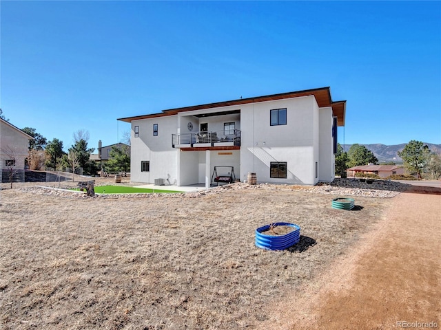 back of property featuring a patio area, stucco siding, and a balcony