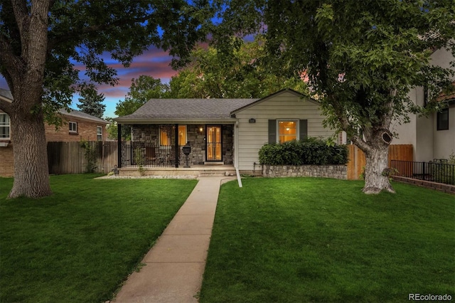 ranch-style house featuring a yard and a porch