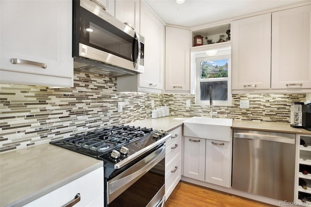 kitchen with light countertops, stainless steel appliances, and tasteful backsplash