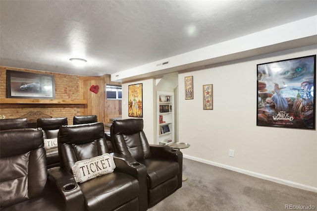 carpeted home theater featuring visible vents and baseboards