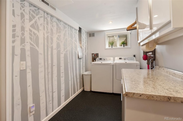 laundry area with laundry area, independent washer and dryer, and visible vents