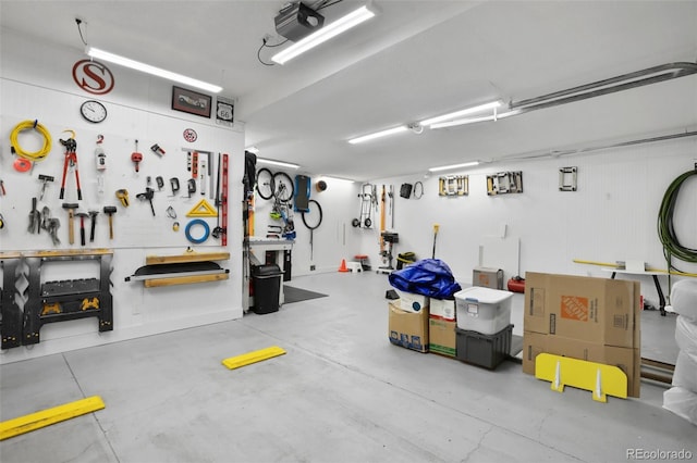 garage with a workshop area and a garage door opener