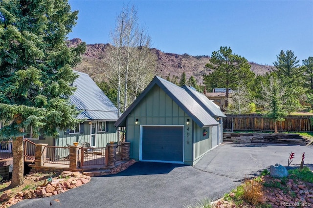 exterior space with a mountain view and fence