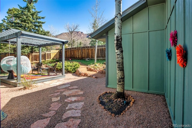 view of yard with a fenced backyard and a mountain view