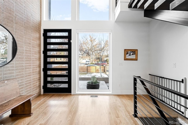 foyer with a high ceiling and light wood-type flooring