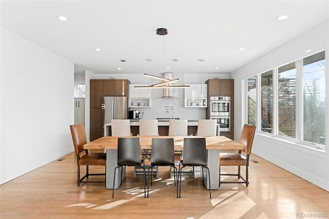 dining area featuring light wood-type flooring