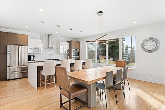 dining space featuring sink and light wood-type flooring