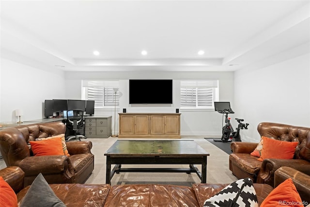 living room with light carpet and a tray ceiling