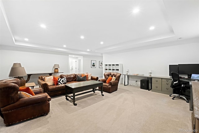 carpeted living room with a raised ceiling