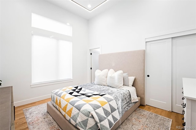 bedroom featuring light wood-type flooring and a closet