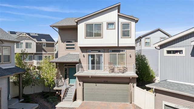 view of front of house with a garage, fence, decorative driveway, roof with shingles, and stairway