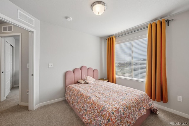 carpeted bedroom featuring visible vents and baseboards