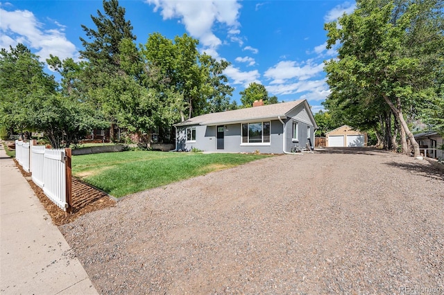 view of front of home with an outbuilding, a garage, and a front yard