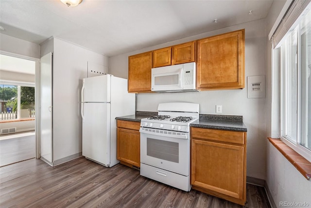 kitchen featuring white appliances and dark wood-type flooring