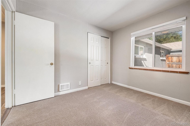 unfurnished bedroom featuring a closet and carpet