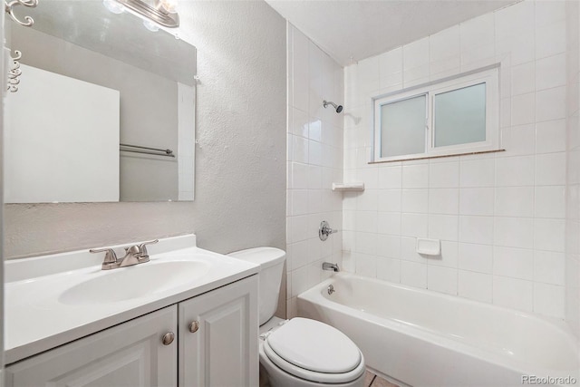 full bathroom with tiled shower / bath combo, vanity, and toilet