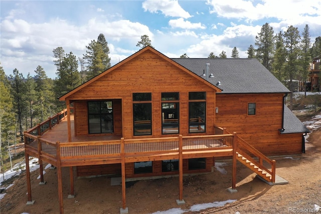 rear view of property with a wooden deck