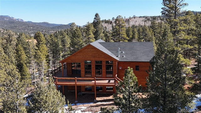 rear view of property with a deck with mountain view