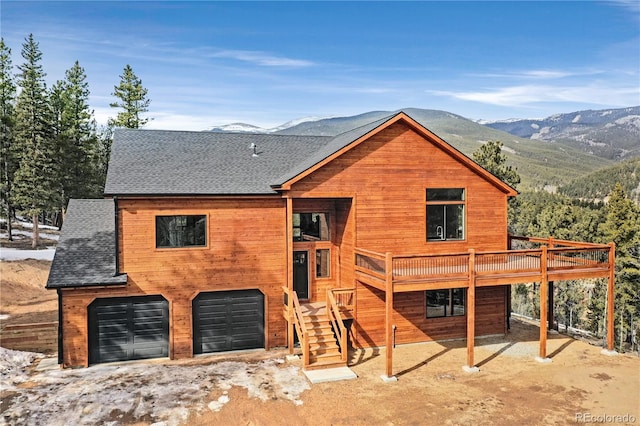 view of front of property featuring a garage and a deck with mountain view