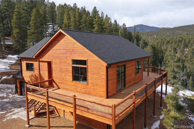 rear view of property featuring a deck with mountain view