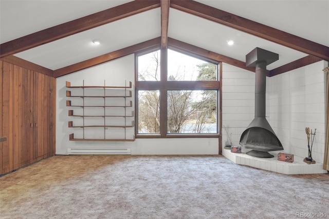 unfurnished living room with lofted ceiling with beams, a wood stove, carpet flooring, and baseboard heating