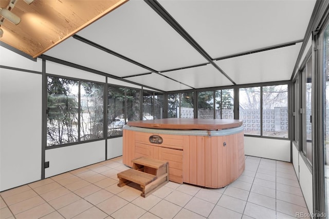 unfurnished sunroom featuring a jacuzzi