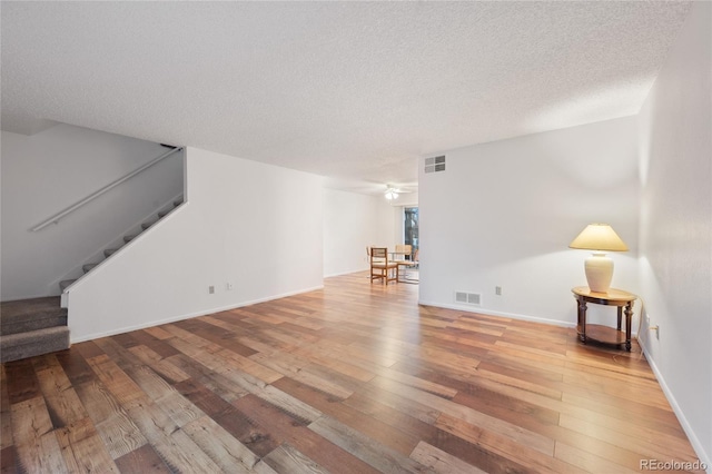 living room featuring hardwood / wood-style floors and a textured ceiling