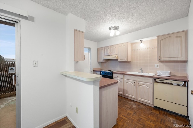 kitchen with sink, decorative backsplash, light brown cabinetry, and white dishwasher