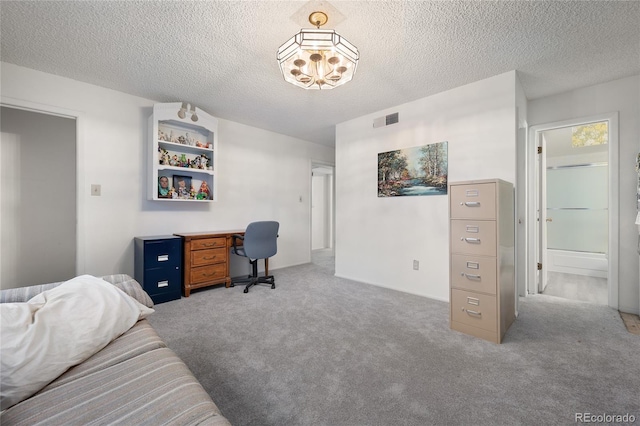 carpeted home office with a textured ceiling