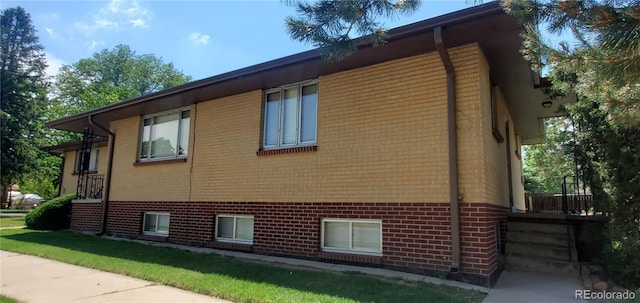 view of side of property with brick siding