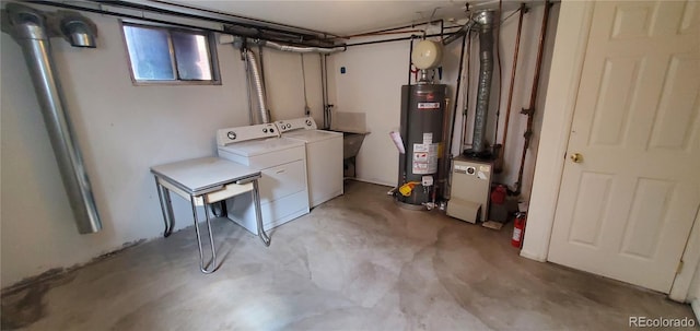 basement with washer and clothes dryer and water heater