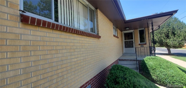 view of property exterior with brick siding