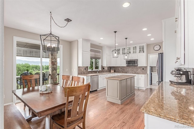 8993 Stonecrest Way, Highlands Ranch, CO 80129 - kitchen featuring appliances with stainless steel finishes, a chandelier, a kitchen island, white cabinets, and recessed lighting