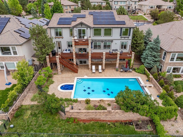 8993 Stonecrest Way, Highlands Ranch, CO 80129 - back of house with a fenced backyard, a deck, stairway, solar panels, and a residential view