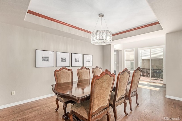 8993 Stonecrest Way, Highlands Ranch, CO 80129 - dining space featuring a chandelier, baseboards, wood finished floors, and a raised ceiling