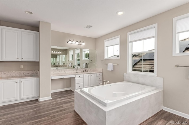 8993 Stonecrest Way, Highlands Ranch, CO 80129 - bathroom with a bath, vanity, wood finished floors, baseboards, and recessed lighting