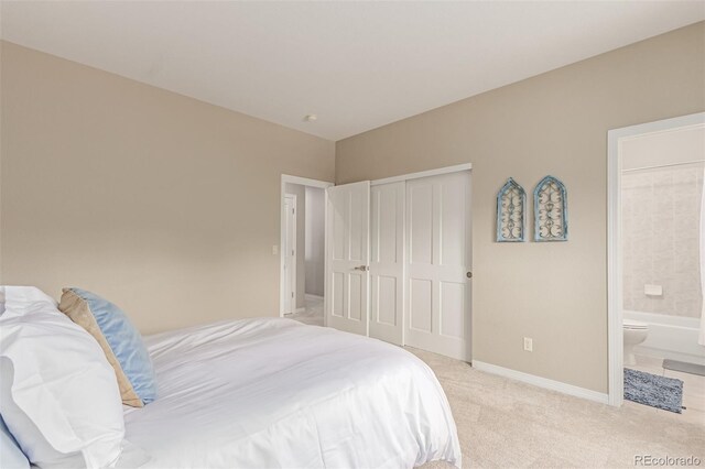 8993 Stonecrest Way, Highlands Ranch, CO 80129 - bedroom featuring light colored carpet, a closet, connected bathroom, and baseboards