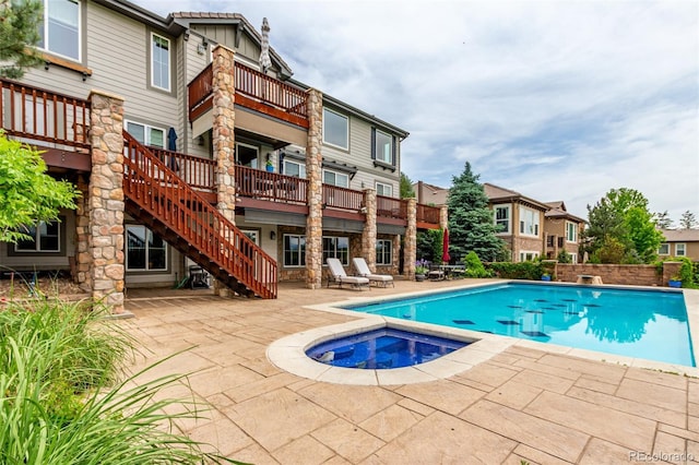 8993 Stonecrest Way, Highlands Ranch, CO 80129 - outdoor pool with an in-ground hot tub, a patio area, and stairs