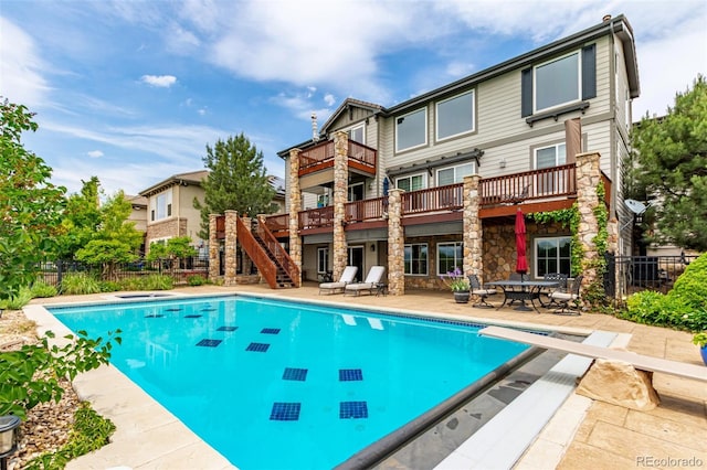 8993 Stonecrest Way, Highlands Ranch, CO 80129 - view of swimming pool featuring a diving board, a patio, stairs, and a deck