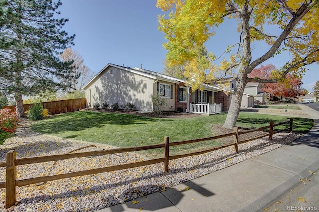 ranch-style house with covered porch and a front lawn