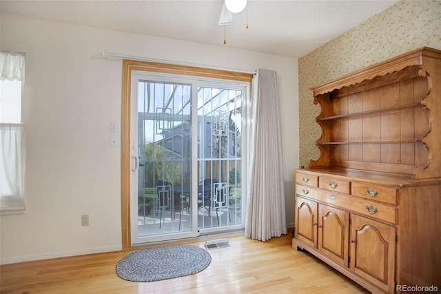 entryway featuring light hardwood / wood-style floors, a textured ceiling, and plenty of natural light