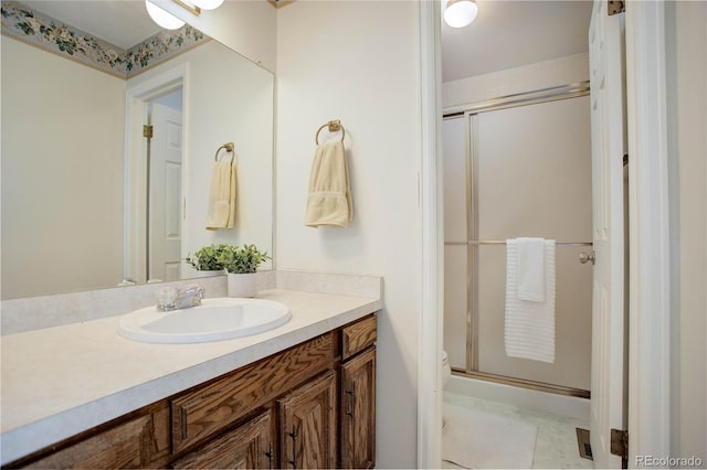 bathroom with vanity, walk in shower, and tile patterned flooring