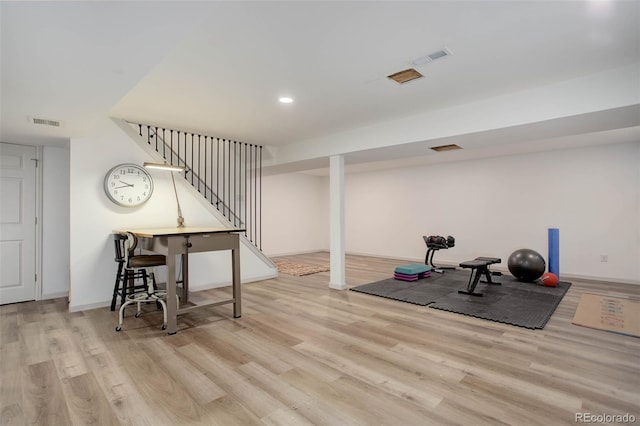 exercise area featuring light hardwood / wood-style floors