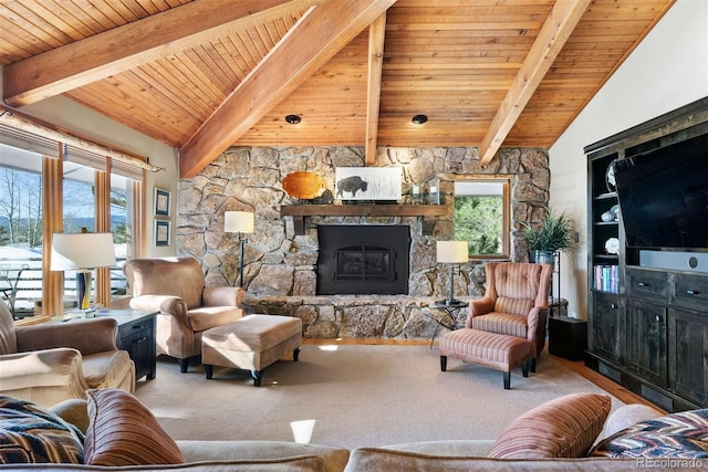 living room featuring beam ceiling, a healthy amount of sunlight, a fireplace, and wood ceiling