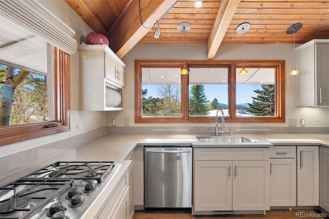 kitchen with stainless steel appliances, hanging light fixtures, beamed ceiling, white cabinets, and wood ceiling